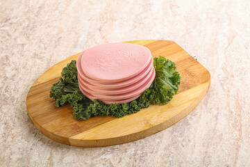 Slices pork sausage over board