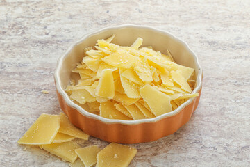 Sliced parmesan cheese heap in the bowl