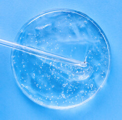 serum gel closeup in petri dish on a blue background	
