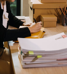 Portrait of Starting small businesses SME owners, two Asian woman check online orders Selling...