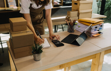 Portrait of Starting small businesses SME owners, two Asian woman check online orders Selling...