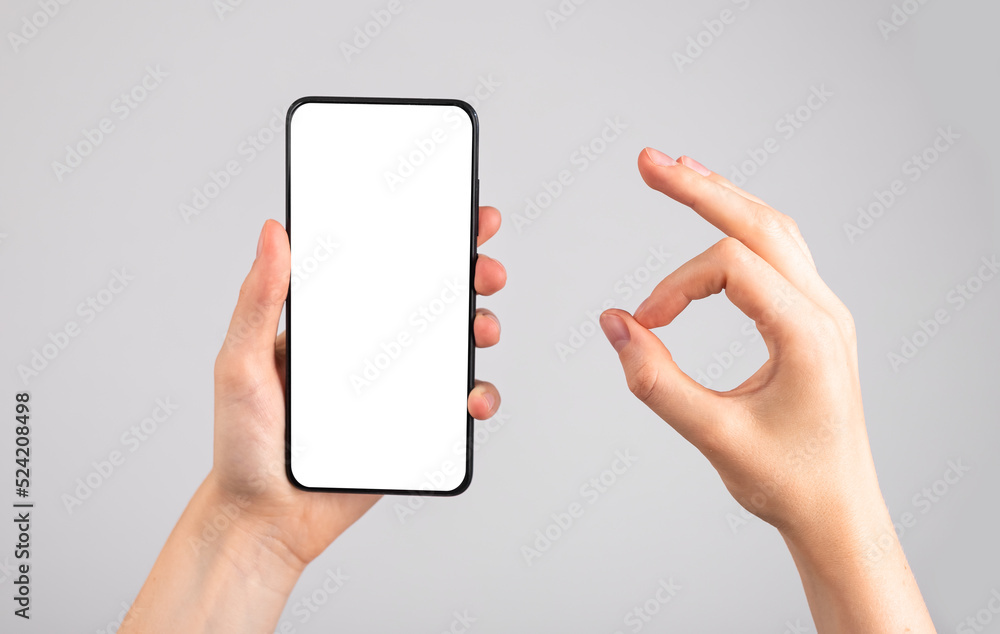 Poster woman holding phone mockup and showing ok gesture. application, website recommendation, approval. an