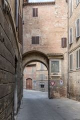 street with arched passage, Siena, Italy