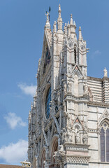 Fototapeta na wymiar Maria Assunta Cathedral facade edge, Siena, Italy