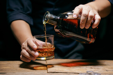 Barman pouring whiskey whiskey glass beautiful night