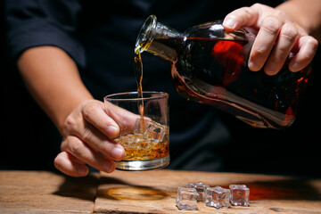 Barman pouring whiskey whiskey glass beautiful night