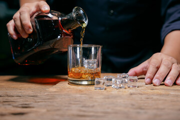 Barman pouring whiskey whiskey glass beautiful night