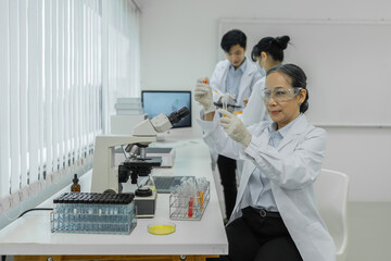 Fototapeta premium Scientist with a test tube containing cannabis extract