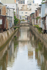 Fototapeta na wymiar 昭和を思わせる川沿いの町並み