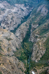 mountain gorge with a steep road and a funicular line in the mountains of Armenia