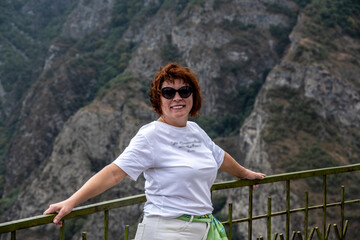 Naklejka premium woman tourist on the observation deck in a picturesque gorge in the mountains of Armenia