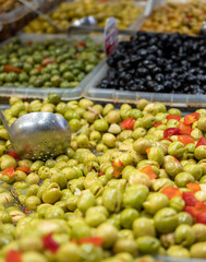 Assortment of pickled green olives on farmers market in Malaga, Andalusia, Spain
