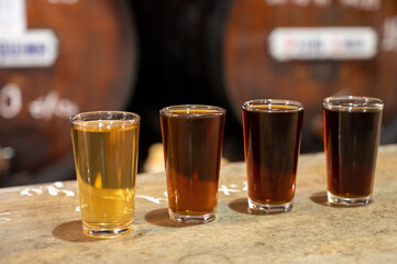 Tasting of different sweet wines from wooden barrels on old bodega in central part of Malaga,...