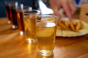 Tasting of different sweet wines from wooden barrels owith cheese n old bodega in central part of Malaga, Andalusia, Spain