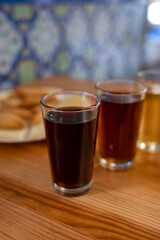 Tasting of different sweet wines from wooden barrels on old bodega in central part of Malaga, Andalusia, Spain