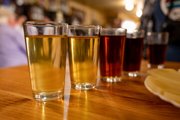Tasting of different sweet wines from wooden barrels on old bodega in central part of Malaga, Andalusia, Spain