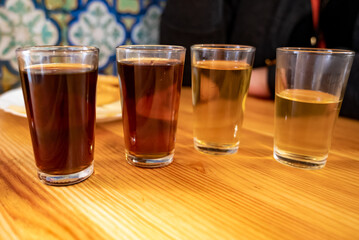 Tasting of different sweet wines from wooden barrels on old bodega in central part of Malaga, Andalusia, Spain