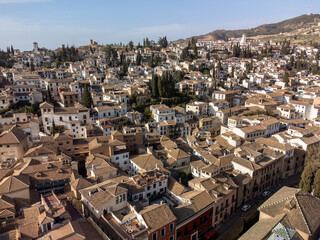 Aerial panoramic view on buildings, old district, mountains and palace, world heritage city Granada, Andalusia, Spain