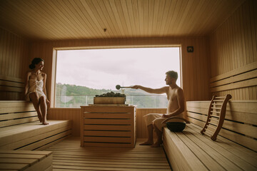 Young couple relaxing in the sauna