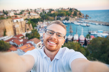 Travel selfie photo Man tourist take background Kaleici Antalya old town port, Mediterranean Sea,...