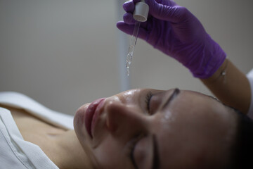 Facial acid peeling mask with retinol and fruit acids in beauty spa salon,
