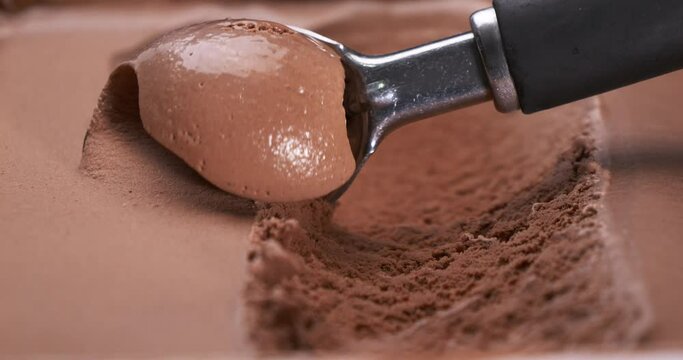 Closeup scooping Ice cream flavored Chocolate, Front view Food concept.
