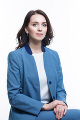 Portrait of Winsome Positive Young Confident Caucasian Business Woman in Blue Checked Suit Posing Over White