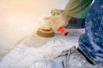Construction workers use concrete polishers and hard floors.
