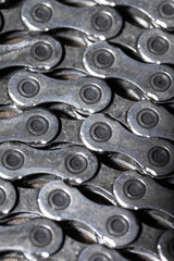 Obraz premium Detailed Closeup View of Used Greasy Oiled Bicycle Chain As A Part of Metal Bicycle Equipment On Stony Background With Contrast Details