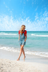 Fototapeta na wymiar Beautiful young woman walking on the beach Varadero , Cuba