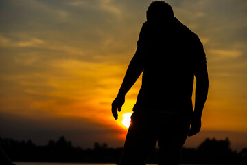 Fototapeta premium male and orange sky and sun set