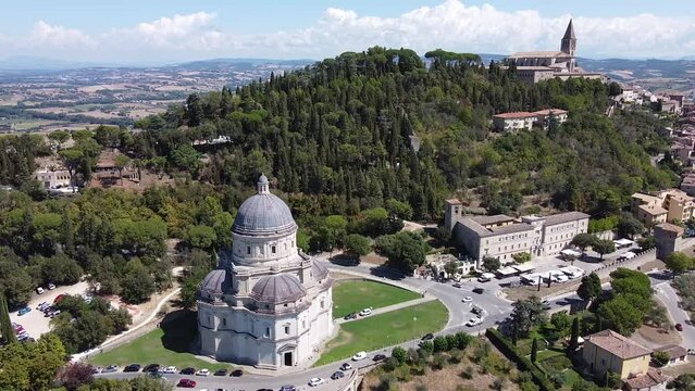 Orbiting Aerial view of Santa Maria della Consolazione, catholic church. Summer season, blue sky sunny day. Todi Umbria. Italy