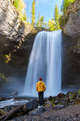 Beautiful waterfall in Canada, couple visit Helmcken Falls, the most famous waterfall in Wells Gray...