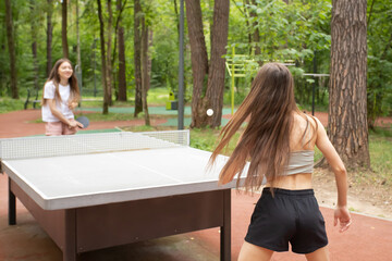 table tennis, teenager playing ping pong in the summer in the park, active leisure