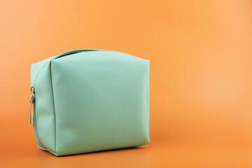 cosmetic bag, beauty case for makeup tools on an orange background
