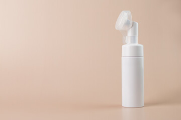 face foam in a bottle, Dispenser for cream, soups, lotion, shampoo, on a beige natural background, copy space, place for text