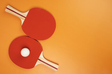 table tennis racket on orange background,copy space