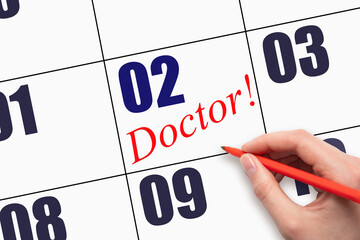 2nd day of the month. Hand writing text DOCTOR on calendar date.