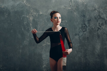 Young girl professional gymnast woman dance rhythmic gymnastics with ribbon at studio.