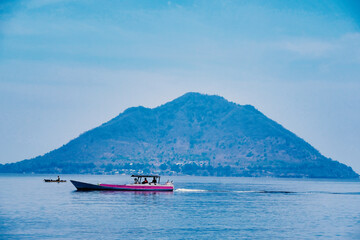 Indonesia Alor Island - Fishing boat and volcanic mountain