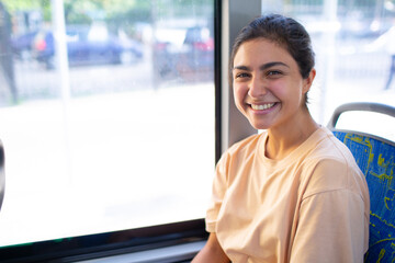 Indian Smiling Woman ride in public transport bus or tram - obrazy, fototapety, plakaty
