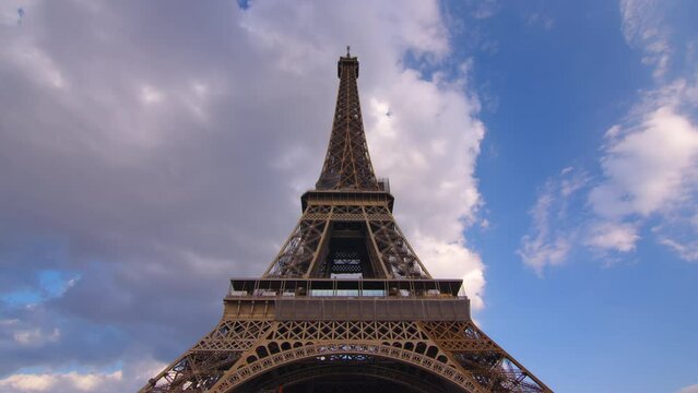 Timelapse, movement of clouds. Sunset, dusk, Eiffel tower, blue sky, top view, paris, 4k, time lapse, France. The most popular tourist attraction in the world.
