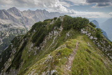 Fototapeta na wymiar view of the highest peaks of the Julian Alps and the path below the peak of Zadnjiški Ozebnik - Triglav National Park