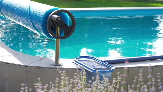Cleaning the pool floor with an underwater vacuum cleaner, pool maintenance concept.