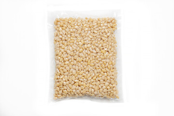 Peeled Pine Nut In Transparent Vacuum Medium Plastic Packaging On White Background.