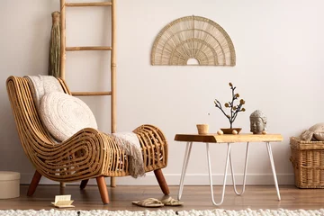 Fotobehang Boho Sunny and bright space of living room with rattan armchair, pillows, carpet, decoration, coffee table, ladder plaid and elegant personal accessories. Cozy home decor. Template.  © FollowTheFlow