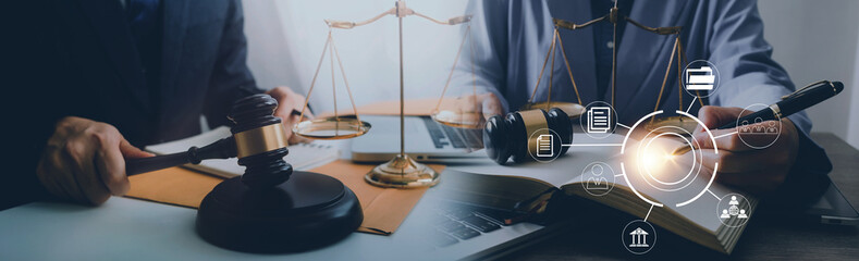 Justice and law concept. Gavel on sounding block in hand's Male judge at a courtroom, working with document law books, report the case on table in modern office.