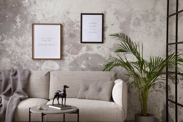 Obraz na płótnie Canvas Sophisticated composition of modern living room with design sofa, coffee table, loft wall, mock up frame, decoration and personal accessories. Wabi sabi concrete wall. Minimalist home decor. Template.