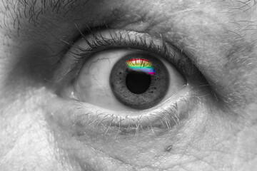 close up of a human eye mono tone with lgbtq color reflection