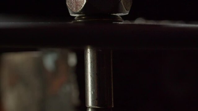 Process of metal rivet installing on steel sheet extreme close view. Fastening tool and traditional method of connection